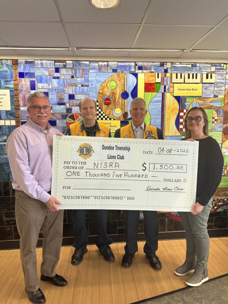 The Dundee Township Lions visited NISRA in Crystal Lake Wednesday and gave them a check for $1,500.00