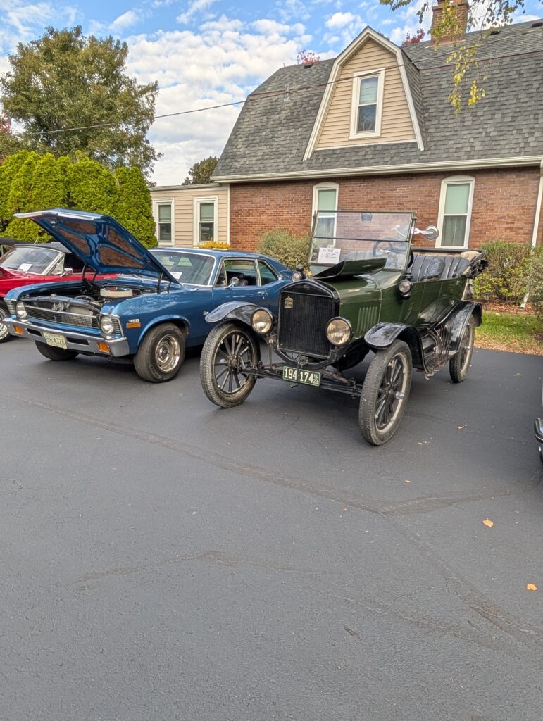 picture of old green car next to a blue nova